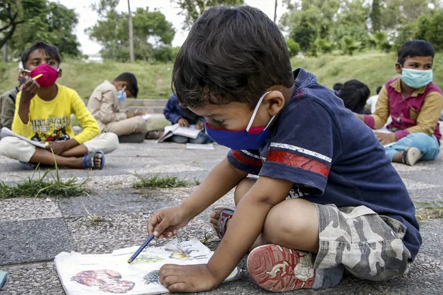 Pakistani children of slum areas, take classes at an open air free school run by thee Pakistani Muhammad Ayub, in Islamabad, Pakistan, 03 June 2020. Muhammad Ayub, who works with civil defense organization during the day, offer his services for free to teach children who don't have access to education. (Photo by Sohail Shahzad/EPA/EFE/Rex Features/Shutterstock)