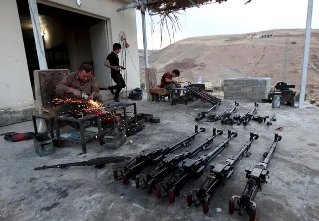 A Kurdish man repairs weapons for Kurdish Peshmerga forces fighting against Islamic State militants, in his shop outside of Arbil, north of Iraq, September 15, 2015. (Photo by Azad Lashkari/Reuters)