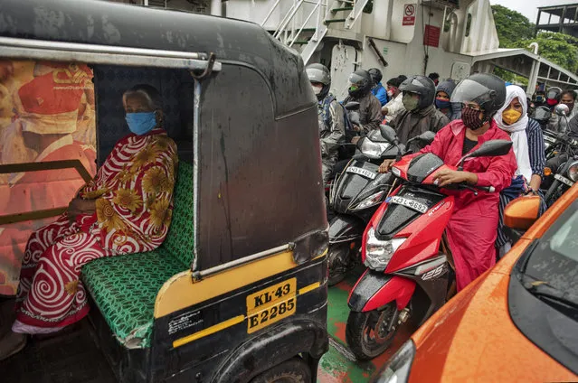 Commuters wearing masks as a precaution against the coronavirus travel in a ferry in Kochi, Kerala state, India, Monday, June 22 2020. India is the fourth hardest-hit country by the COVID-19 pandemic in the world after the U.S., Russia and Brazil. (Photo by R.S. Iyer/AP Photo)