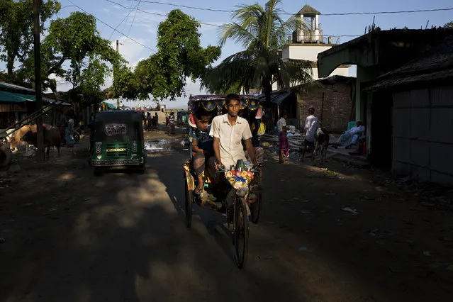 In this September 21, 2017 photo, a bicycle rickshaw driver in Shah Porir Dwip, an island by the Bay of Bengal at Bangladesh’s southern tip. (Photo by Bernat Armangue/AP Photo)