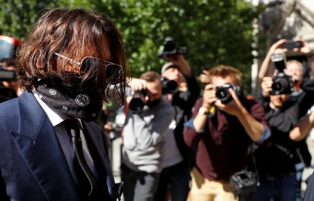 Hollywood actor Johnny Depp, wearing a face mask or covering due to the COVID-19 pandemic, arrives on the first day of his libel trial against News Group Newspapers (NGN), at the High Court in London, on July 7, 2020. A libel trial was due to begin on Tuesday between Hollywood actor Johnny Depp and a British tabloid newspaper over claims that he was violent to his former wife, Amber Heard. (Photo by Peter Nicholls/Reuters)