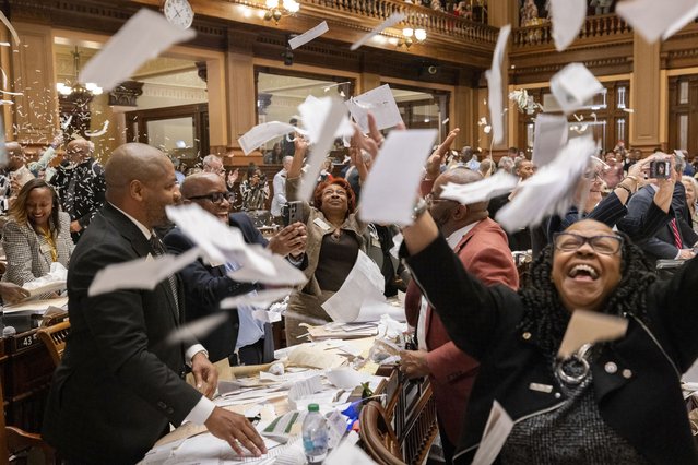 State representatives toss papers in the air at the House of Representatives at the Capitol in Atlanta on Sine Die, Friday, April 4, 2025, the final day of the legislative session. (Photo by Arvin Temkar/Atlanta Journal-Constitution via AP Photo)