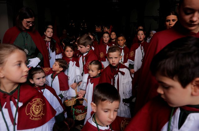 People from the Huerto brotherhood, acting as penitents, leave a church to take part in a procession during Holy Week in Ronda, southern Spain on April 14, 2025. (Photo by Jon Nazca/Reuters)