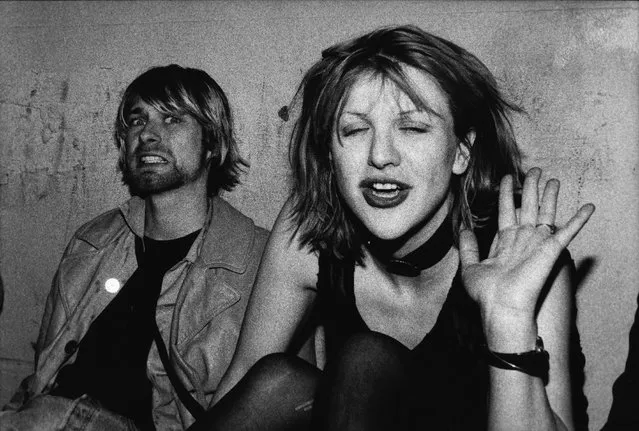 Kurt Cobain and Courtney Love pose for photograph, Kurt grimacing for the camera and Courtney waving, on VIP balcony during Mudhoney concert at the Hollywood Palladium on December 4, 1992 in Los Angeles, California. (Photo by Lindsay Brice/Getty Images)