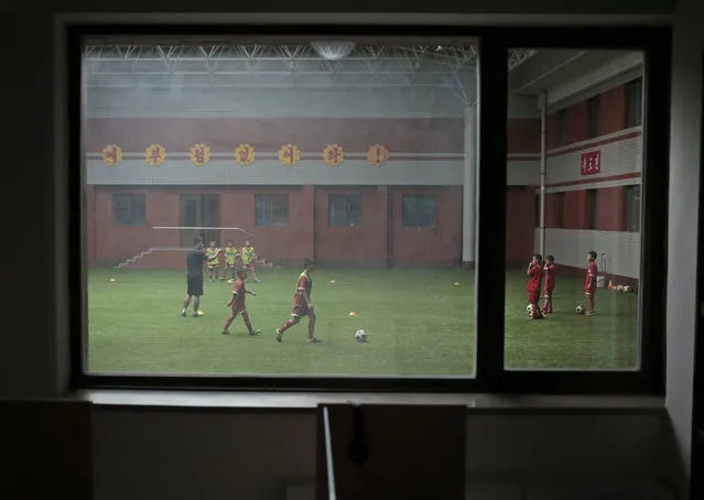 Children practice soccer at Pyongyang International Football School in Pyongyang, North Korea, Wednesday, August 24, 2016. North Korea has poured funds into the development and training of promising athletes over the past several years in an effort to fulfill one of leader Kim Jong Un's primary goals to become a country be reckoned with on the global sports stage. (Photo by Dita Alangkara/AP Photo)
