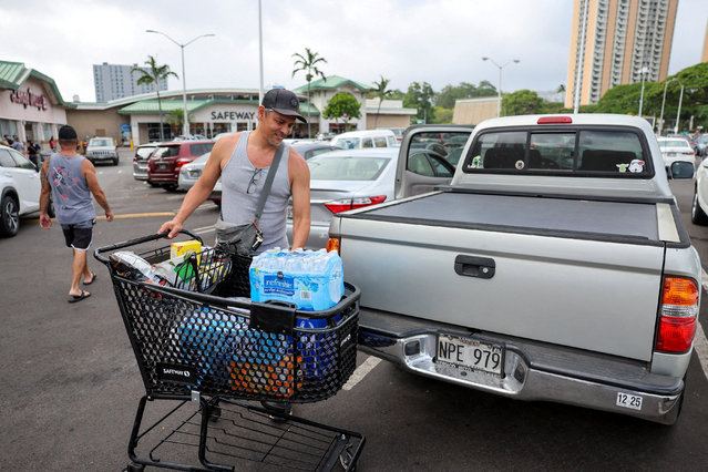 Honolulu resident Adam Jung loads water and other supplies into his vehicle after authorities warned residents of the possibility of destructive tsunami waves, following an earthquake which earlier struck off Russia's Far Eastern Kamchatka Peninsula, in Honolulu, Hawaii on July 30, 2025. (Photo by Marco Garcia/Reuters)