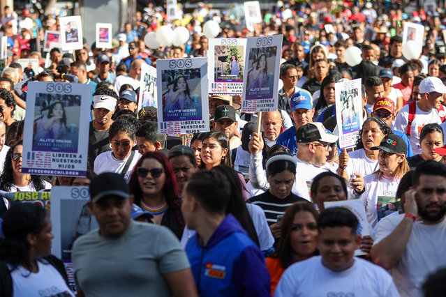 People hold photos of children who remain in the US after being separated from their parents during a demonstration in Caracas on July 10, 2025. Hundreds protested in Caracas on July 10, 2025, to demand the return to Venezuela of at least 30 children who were separated from their parents during the deportation process from the United States. (Photo by Pedro Mattey/AFP Photo)