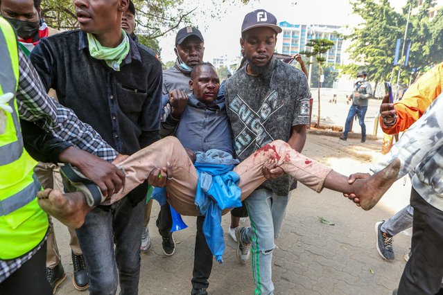 An injured demonstrator is carried to safety during a protest in the central business district in Nairobi, Kenya, 25 June 2025, marking the first anniversary of the Gen Z protests that culminated with the storming of the national parliament. (Photo by EPA/Stringer)