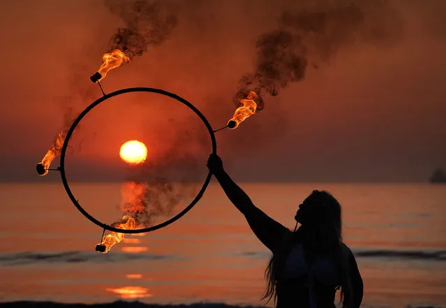 Fire and Light Choreographer Penella Bee from Bee-Enchanted practices her routine on Seaburn beach in Sunderland, England early morning on September 15, 2020. (Photo by Owen Humphreys/PA Images via Getty Images)