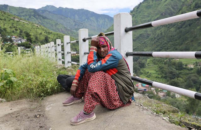 Kaali Devi, whose family members are missing, waits near the helipad at Bhatwari area, during a search and rescue operation in the Uttarkashi district, Uttarakhand state, northern India, 07 August 2025. State officials said a powerful cloudburst struck the Dharali area of Uttarkashi district in Uttarakhand triggering flash floods that swept away a village, leaving several people dead and scores missing. (Photo by Rajat Gupta/EPA)