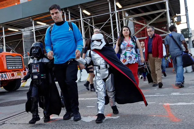 A man dressed in costume walks with children enroute to the New York Comic Con with other commuters in New York, U.S., October 6, 2016. (Photo by Shannon Stapleton/Reuters)