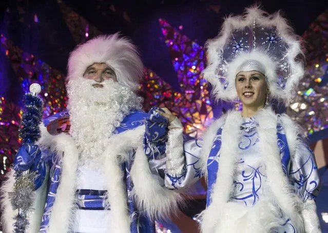 People dressed as Father Frost, the equivalent of Santa Claus, and Snow Maiden take part in the contest “Yolka-fest-2014” (Fir-festival-2014) in Minsk December 12, 2014. (Photo by Vasily Fedosenko/Reuters)