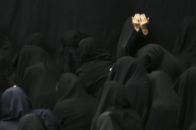 Iranian Shiite Muslim women mourn during a ceremony at Sadat Akhavi Mosque in Tehran, Iran, Sunday, October 9, 2016, three days prior to the death anniversary of 7th century Shiite Imam Hussein, the grandson of Prophet Muhammad, who was killed in a battle in Karbala in present-day Iraq. (Photo by Ebrahim Noroozi/AP Photo)