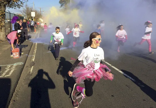 In this November 5, 2016 photo, children participate in the fun run at the annual Vicki Soto 5K race in Stratford, Conn. The race is held by the Soto family to raise money to fund scholarships for students interested in careers in education. First-grade teacher Vicki Soto was one of 26 people killed during a shooting inside the Sandy Hook Elementary School on Dec. 14, 2012, in Newton, Conn. (Photo by Pat Eaton-Robb/AP Photo)