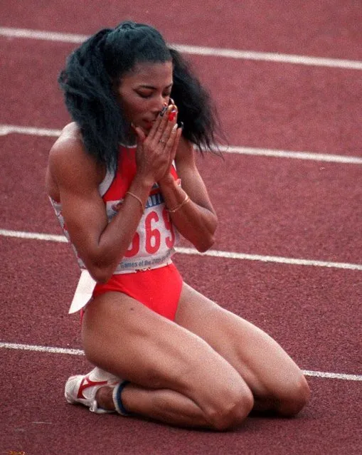 Florence Griffith Joyner falls to her knees in a prayerful manner after taking then 200-meter Olympic final in world record time in Seoul, in this Sept. 29, 1988 photo. Joyner died Monday September 21, 1998 in Mission Viejo, Calif.,  of an apparent heart seizure. She was 38. (Photo by Rusty Kennedy/AP photo)