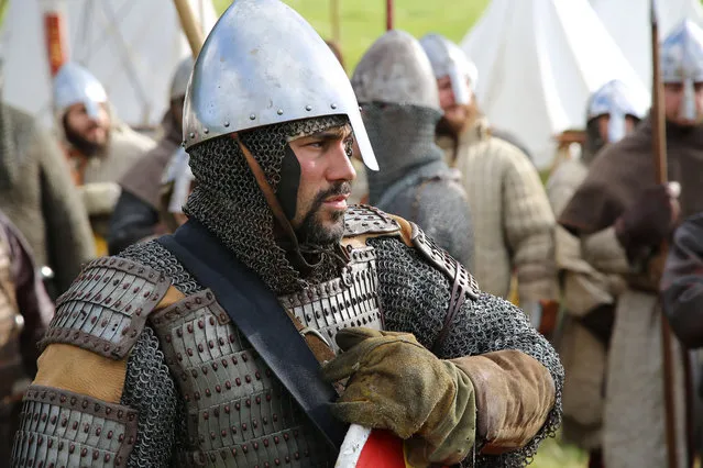 Re-enactors gather in Battle, near Hastings to re-enact the ancient clash between King Harold and William the Conqueror on the 950th anniversary of the fabled Battle of Hastings, Saturday October 15, 2016. Some thousands of history buffs including many in full costume marked the 1066 Battle of Hastings with a dramatic reenactment that commemorates one of the most important events in British history. (Photo by Angus Dunsire/PA Wire via AP Photo)