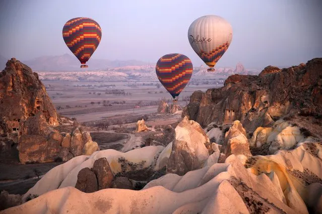 Tourists take part in hot air balloon rides on the first day of the New Year in Cappadocia of Nevsehir, Turkiye on January 1, 2023. (Photo by Behcet Alkan/Anadolu Agency via Getty Images)