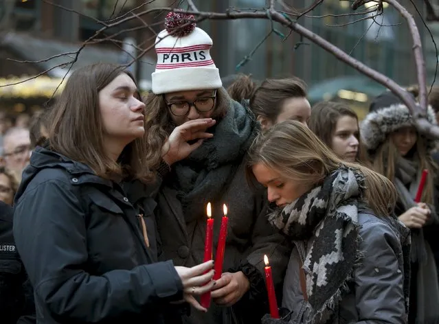Three girls hold candles during a vigil, in memory of the victims of the Paris attacks, outside French embassy in Montreal, November 14, 2015. (Photo by Christinne Muschi/Reuters)
