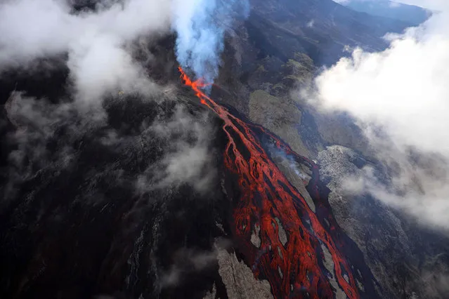 A picture taken on April 2, 2020, shows lava oozing down the Piton de le Fournaise volcano during an eruption, on the French Indian Ocean island of La Reunion. (Photo by Richard Bouhet/AFP Photo)