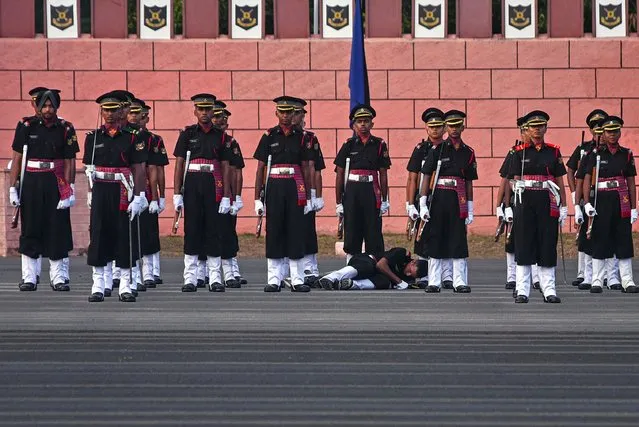 An Indian army cadet collapses during a passing out parade at Officers Training Academy (OTA), in Chennai, India, 29 April 2023. A total of 121 gentlemen cadets and 36 women cadets courses got commissioned into various arms and services of the Indian Army and 29 cadets from Bhutan also completed their training. The newly commissioned officers, donning their ranks and regimental accouterments, swore allegiance to the country and the Constitution of India, committing to “Serve with Honor” to safeguard the honor of the country. (Photo by Idrees Mohammed/EPA)