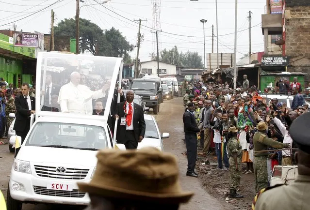 Pope Francis waves as he arrives at the Kangemi slums in the outskirt of Kenya's capital Nairobi, November 27, 2015. (Photo by Noor Khamis/Reuters)