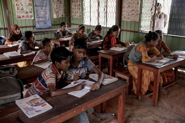 Children attend a class at the only school on Char Youthnet island, run by an NGO, in Kurigram, Bangladesh, on October 28, 2025. (Photo by Mohammad Ponir Hossain/Reuters)