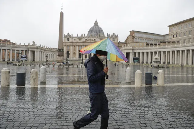 A man walks past an almost empty St. Peter's Square at the Vatican, Sunday, January 24, 2021. Ailing Pope Francis, making limited public appearances due to persistent pain, drew attention to the plight of homeless people in winter, including a Nigerian man who froze to death not far from the Vatican. Francis on Sunday asked for prayers for the man, who he said was 46, named Edwin, and who was “ignored by all, abandoned, even by us”. (Photo by Gregorio Borgia/AP Photo)