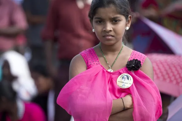 A girl waits for Pope Francis arrival to Our Lady of Madhu shrine, in Madhu, Sri Lanka, Wednesday, January 14, 2015. Pope Francis traveled to the jungles of war-torn northern Sri Lanka on Wednesday to show solidarity with the victims of the country's 25-year civil war and urge forgiveness and reconciliation “for all the evil which this land has known”. (Photo by Alessandra Tarantino/AP Photo)