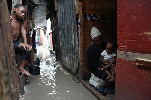 People stay inside a shelter for families displaced by gang violence, flooded by rain brought by Hurricane Melissa, in Port-au-Prince, Haiti, Wednesday, October 29, 2025. (Photo by Odelyn Joseph/AP Photo)