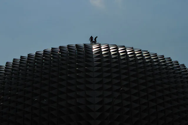 “Top Of The Roof”. The two workers were working on top of one of the world most famous theatre, the Esplanade. Location: Esplanade – Theatres On The Bay, Marina Bay, Singapore. (Photo and caption by K. W. Phua/National Geographic Traveler Photo Contest)