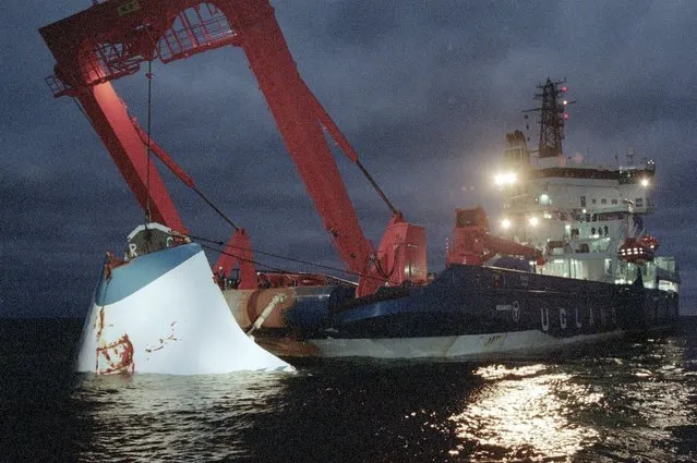 In this November 19, 1994 file photo, the bow door of the sunken passenger ferry M/S Estonia is lifted up from the bottom of the sea, off Uto Island, in the Baltic Sea. Sweden's government wants divers to go down to the wreck of one of Europe’s deadliest peacetime maritime disasters, the sinking of a ferry in the Baltic Sea in 1994 that killed 852 people, in order to check claims of a large hole in the hull. A 1997 report had concluded that the M/S Estonia  – that was sailing from Tallinn to Stockholm  – sank after the bow door locks failed in a storm, and flatly rejected the theory of a hole, which has long been the focus of speculate on about a possible explosion on board. Sweden's home affairs minister said on Friday, Dec. 18, 2020 that the government wants divers to investigate, but gave no timeline for an official dive. (Photo by Jaakko Aiikainen/Lehtikuva via AP Photo, File)
