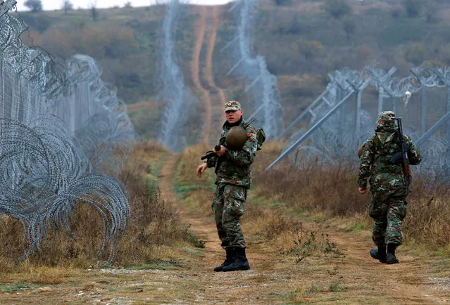 Macedonian Army personnel patrol near the razor wire fence at the border with Greece, in Gevgelija, Macedonia, November 25, 2016. (Photo by Ognen Teofilovski/Reuters)
