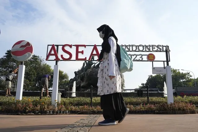 A pedestrian passes by a sign of the Association of Southeast Asian Nations (ASEAN) in Jakarta, Indonesia, Monday, July 10, 2023. Myanmar's prolonged civil strife, tensions in the disputed South China Sea and concern over arms buildups in the region are expected to dominate the agenda when Southeast Asia's top diplomats gather for talks this week in Indonesia. (Photo by Achmad Ibrahim/AP Photo)