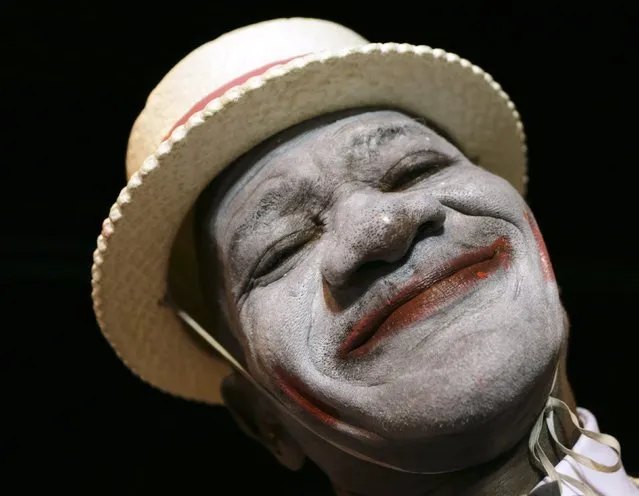 A minstrel, one of several masqueraders who paraded before judges in the traditional mas competition held by the National Carnival Commission at Victoria Square, smiles for a picture in the capital Port-of-Spain Februrary 11, 2015. The competition is one of several held in the weeks leading up to the traditional two-day Carnival street parade next Monday and Tuesday. (Photo by Andrea De Silva/Reuters)