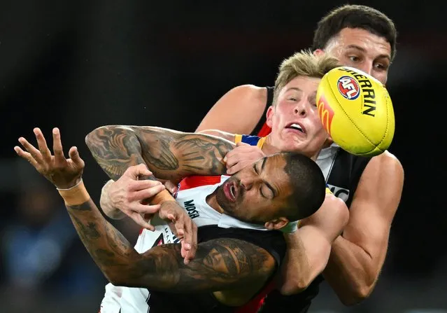 Bradley Hill of the Saints handballs whilst being tackled by Jaspa Fletcher of the Lions during the round 14 AFL match between St Kilda Saints and Brisbane Lions at Marvel Stadium, on June 23, 2023, in Melbourne, Australia. (Photo by Quinn Rooney/Getty Images)