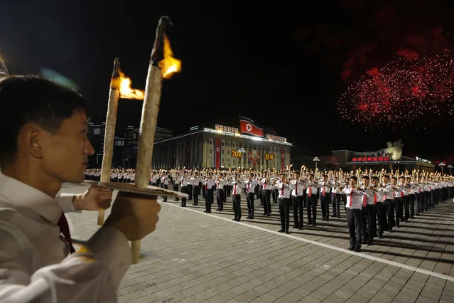 North Korean youths holding torches march during a torch light march at the Kim Il Sung Square in conjunction with the 70th anniversary of North Korea's founding day in Pyongyang, North Korea, Monday, September 10, 2018. (Photo by Kin Cheung/AP Photo)