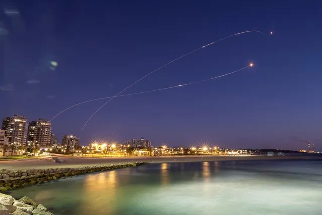Streaks of light are seen as Israel's Iron Dome anti-missile system intercept rockets launched from the Gaza Strip towards Israel, as seen from Ashkelon on May 19, 2021. (Photo by Amir Cohen/Reuters)