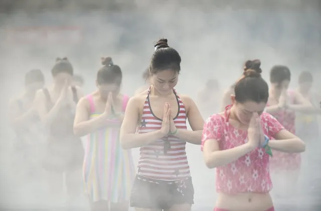 Women practise yoga at a hot spring in Luoyang, Henan Province, China, January 17, 2016. (Photo by Reuters/Stringer)