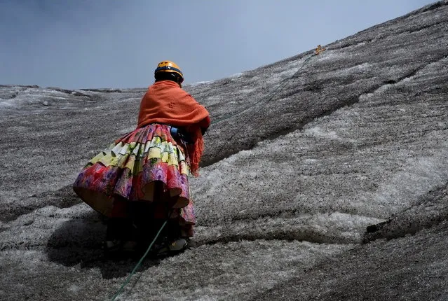 BOLIVIA: An Aymara indigenous woman practises climbing on the Huayna Potosi mountain, Bolivia April 6, 2016. Two years ago, about a dozen Aymara indigenous women, aged 42 to 50, who worked as porters and cooks for mountaineers at base camps and mountain climbing refuges on the steep, glacial slopes of Huayna Potosi, an Andean peak outside La Paz, Bolivia, put on crampons under their wide traditional skirts and started to do their own climbing. (Photo by David Mercado/Reuters)