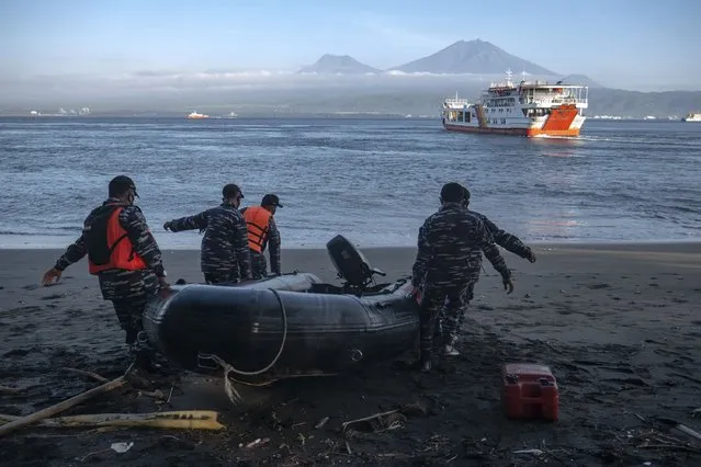 Indonesian Navy personnel prepare for a search rescue operation for victims of the sinking ferry KMP Yunice near Gilimanuk Port on Bali Island, Indonesia, Wednesday, June 30, 2021. Rescuers on Wednesday were searching for people missing in rough seas overnight. (Photo by Fauzy Chaniago/AP Photo)