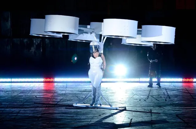 Lady Gaga demonstrates the Volantis transport prototype “flying dress” designed by TechHaus – Studio XO during the ARTPOP album release and artRave event at the Brooklyn Navy Yard on Sunday, November 10, 2013 in New York City. (Photo by Evan Agostini/AP Photo/Invision)