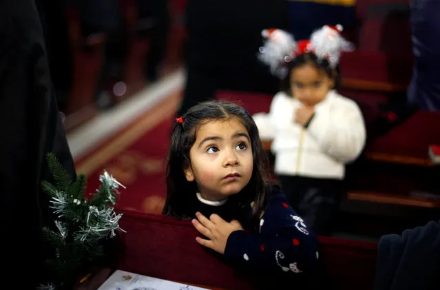 A Palestinian girl attends a mass ahead of Christmas at Der Latin church in Gaza City December 18, 2016. (Photo by Suhaib Salem/Reuters)