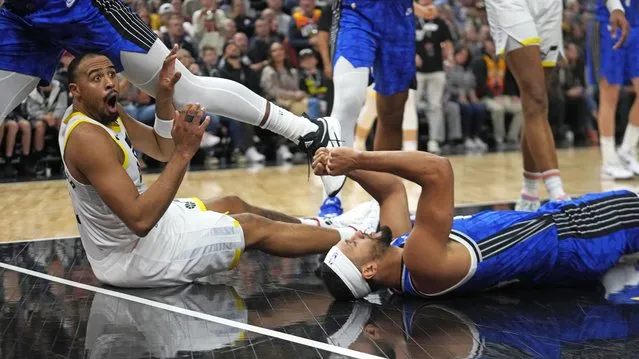 Orlando Magic guard Jalen Suggs, right, celebrates after Utah Jazz guard Talen Horton-Tucker, left, was called for charging during the second half of an NBA basketball game Thursday, November 2, 2023, in Salt Lake City. (Photo by Rick Bowmer/AP Photo)