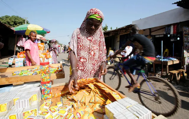 A woman sells merchandise at a market in Serekunda, Gambia December 3, 2016. (Photo by Thierry Gouegnon/Reuters)