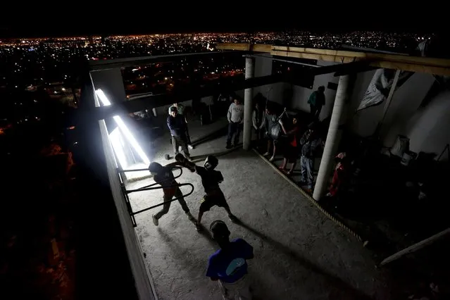 Residents take part in a boxing training session at the rooftop of an apartment, that is being used as a gym, as part of the Barrio Esperanza (Hope neighbourhood) project at the rough Cerro de la Campana neighbourhood in Monterrey, Mexico, January 29, 2016. The Barrio Esperanza project was started within the neighbourhood with the goal of improving the lives of the residents of the barrio through the introduction of health services, education, sports, employment opportunities and infrastructure upgrades, according to local media. (Photo by Daniel Becerril/Reuters)