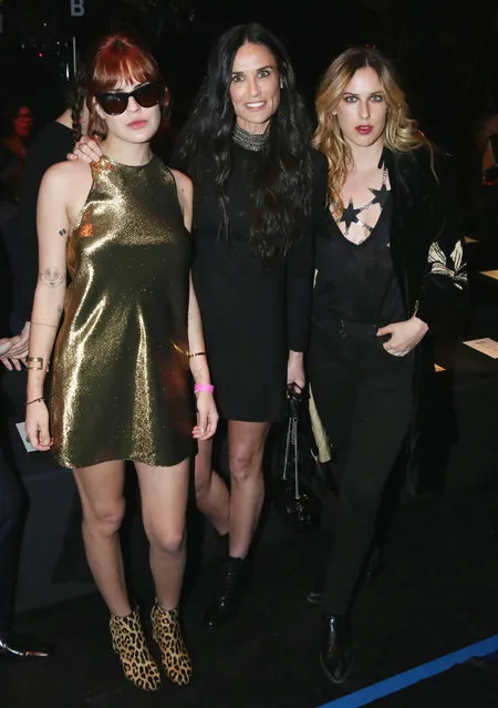 Demi Moore, center, Scout Willis, right, and Tallulah Willis attend Saint Laurent at the Palladium on Wednesday, February 10, 2016 in Los Angeles. (Photo by Matt Sayles/Invision/AP Photo)