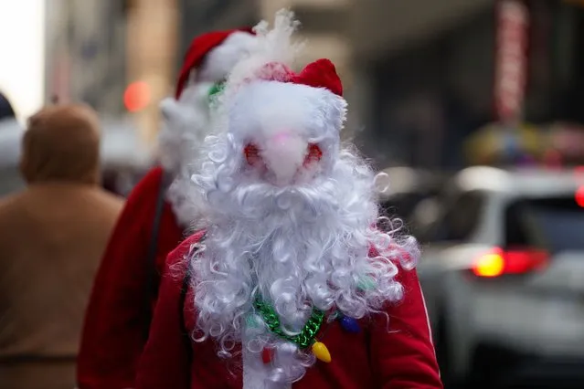 A reveller smokes as he attends the SantaCon in New York City, New York, U.S., December 9, 2023. (Photo by David Dee Delgado/Reuters)