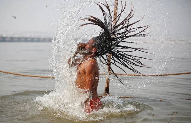 A Sadhu or a Hindu holy man takes a holy dip at Sangam, the confluence of the Ganges, Yamuna and Saraswati rivers, during “Kumbh Mela”, or the Pitcher Festival, in Prayagraj, previously known as Allahabad, India, February 2, 2019. (Photo by Adnan Abidi/Reuters)