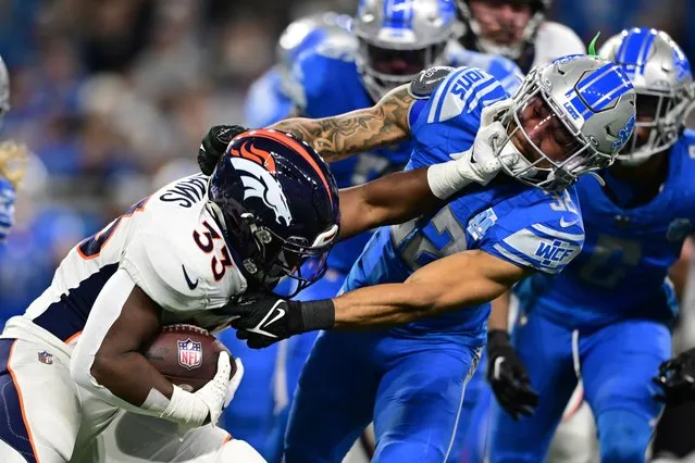 Detroit Lions safety Brian Branch (32) takes down Denver Broncos running back Javonte Williams (33) during the first half of an NFL football game, Saturday, December 16, 2023, in Detroit. (Photo by David Dermer/AP Photo)