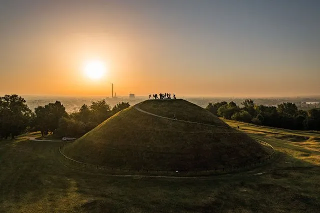 People gathered at the Krakus Mound observe the sunrise on the day of the Summer Solstice sunrise on June 21, 2021 in Krakow, Poland. (Photo by Jan Graczynski/East News/Rex Features/Shutterstock)